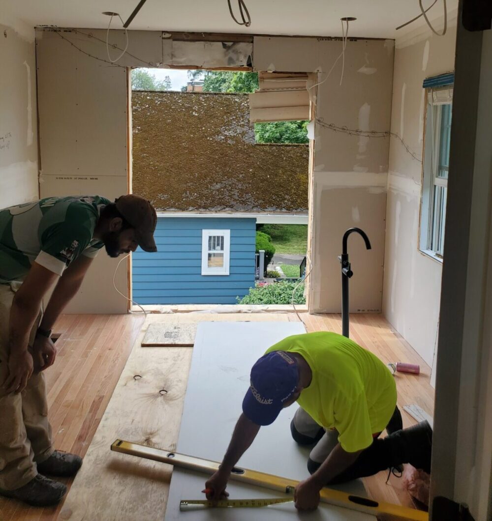 Workers drywall installation